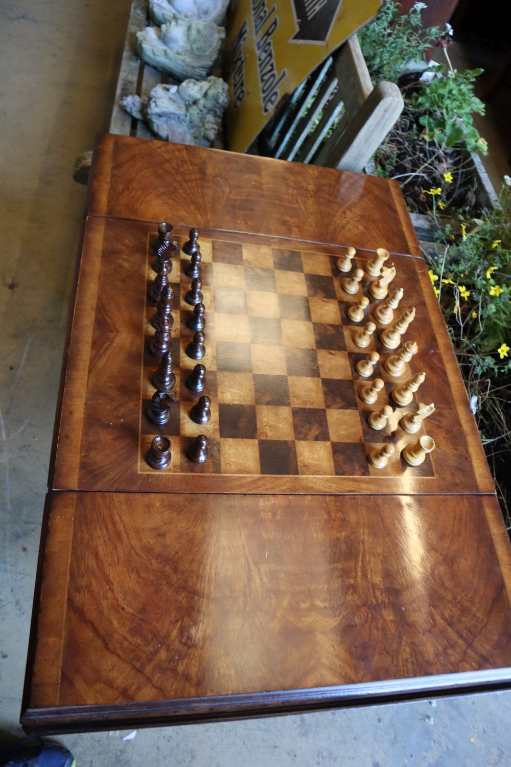 A George III style walnut sofa / games table with sliding reversible top, includes chess and backgammon pieces, width 94cm depth 60cm
